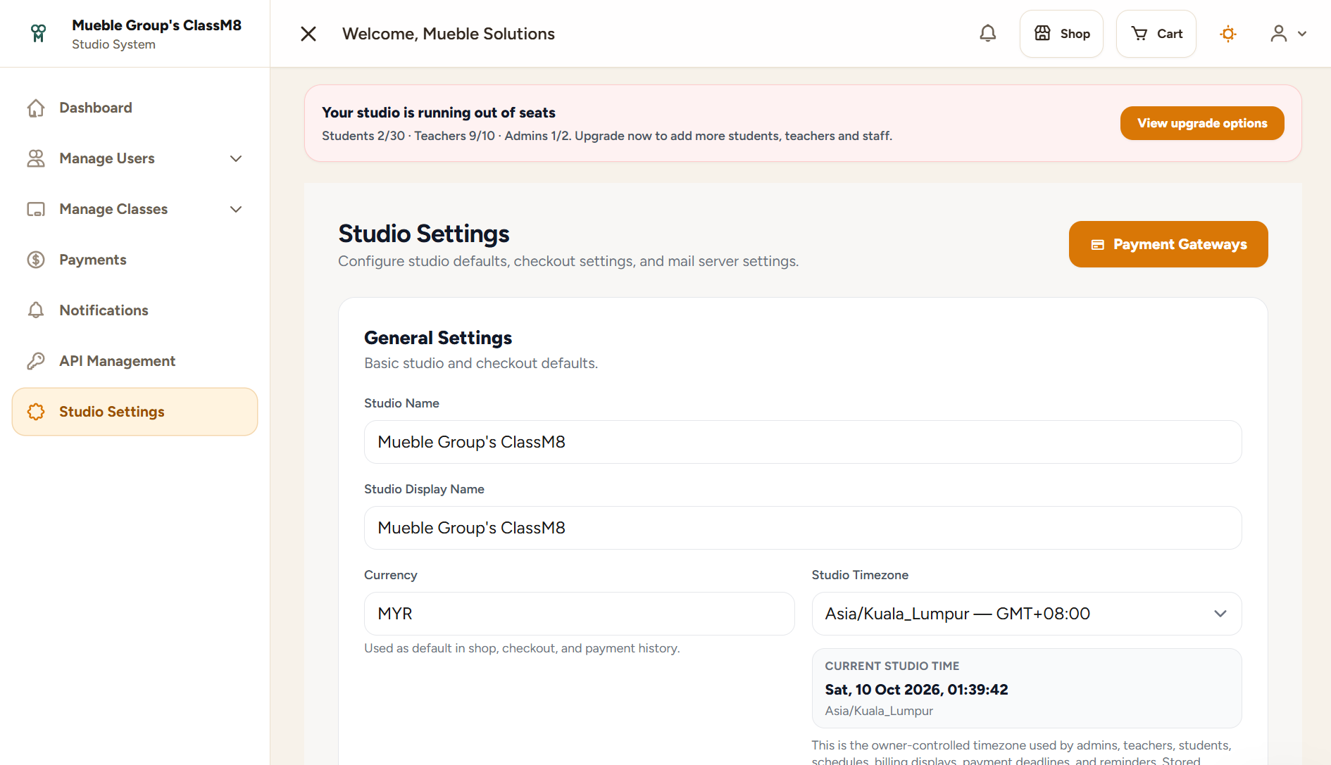 ClassM8 studio settings page with currency, timezone and payment gateway configuration entry point